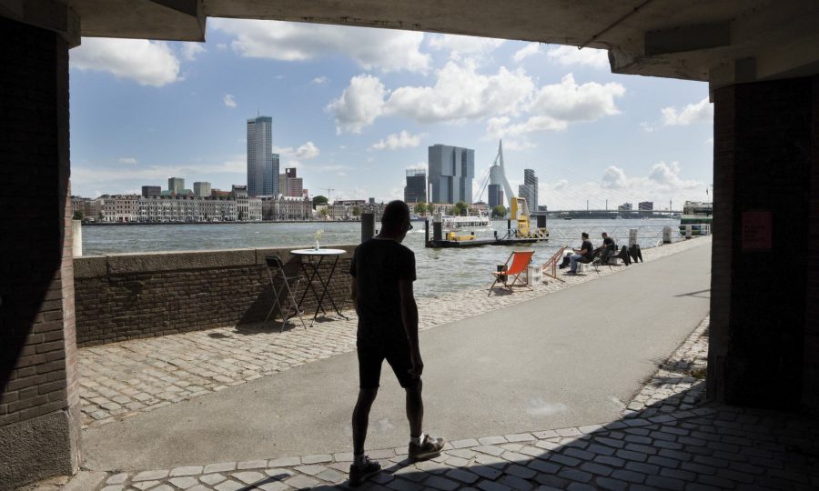 A person walks past the harbour in Rotterdam