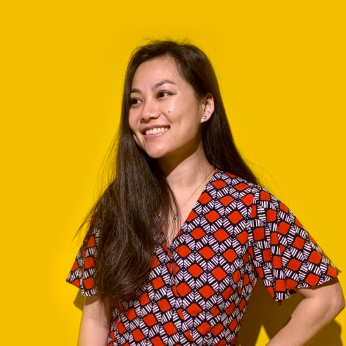 Picture of Micky Chen smiling on a yellow background
